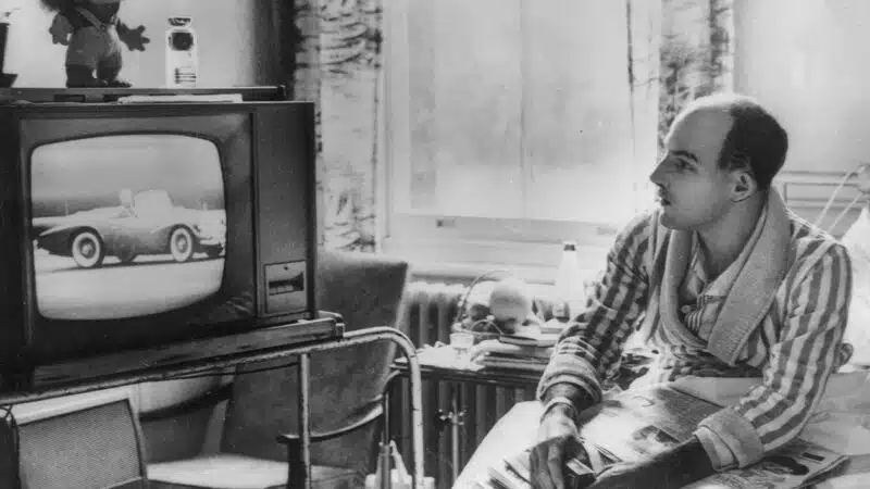 Stirling Moss watches motor racing from his bed at Atkinson Morleys hospital in 1962