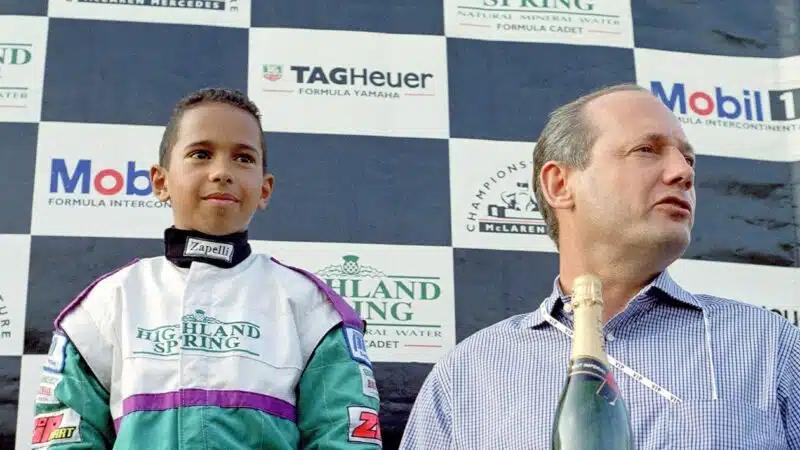 Lewis Hamilton with Ron Dennis on karting championship podium in 1996