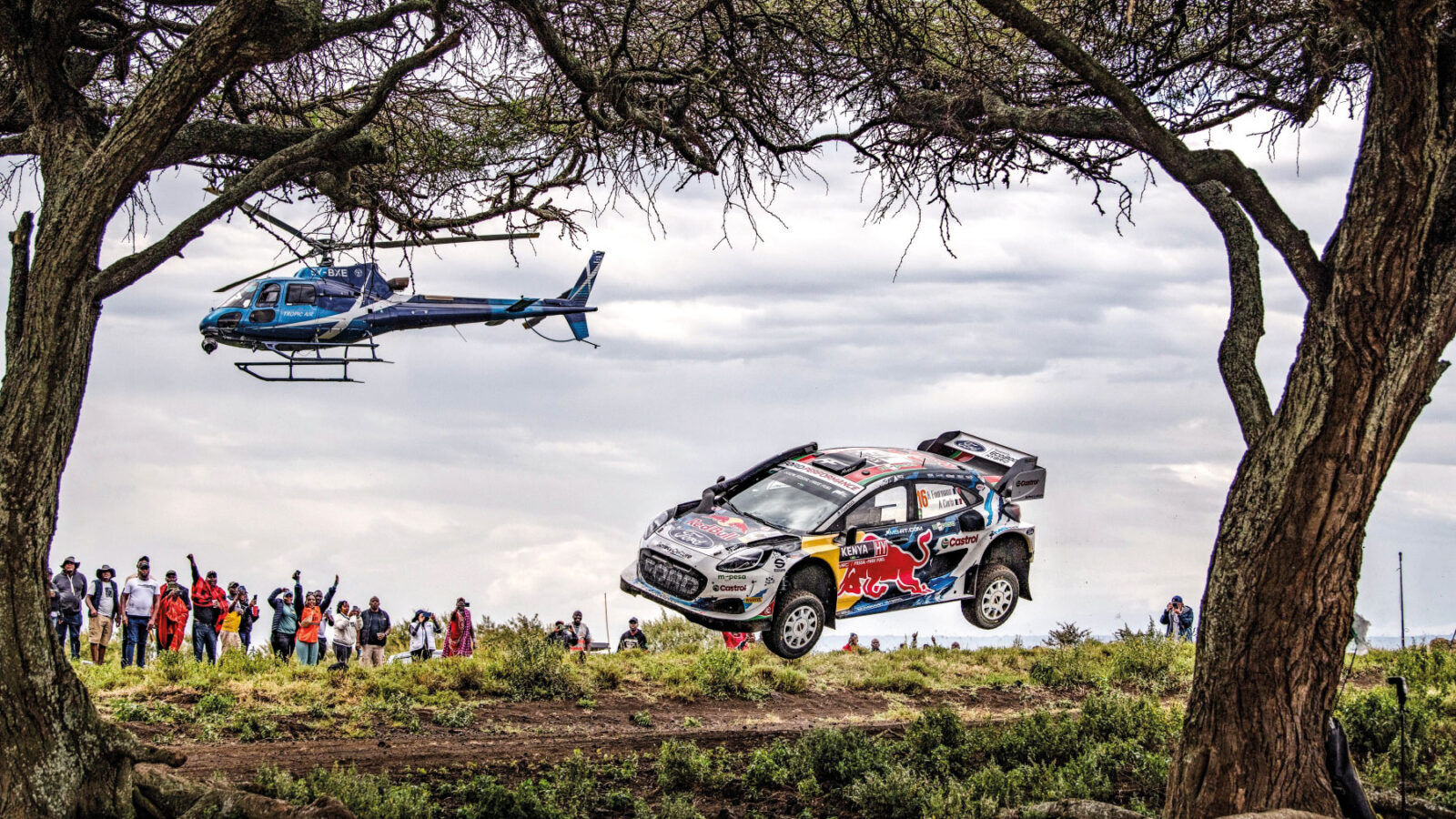WRC car lying through the air with helicopter