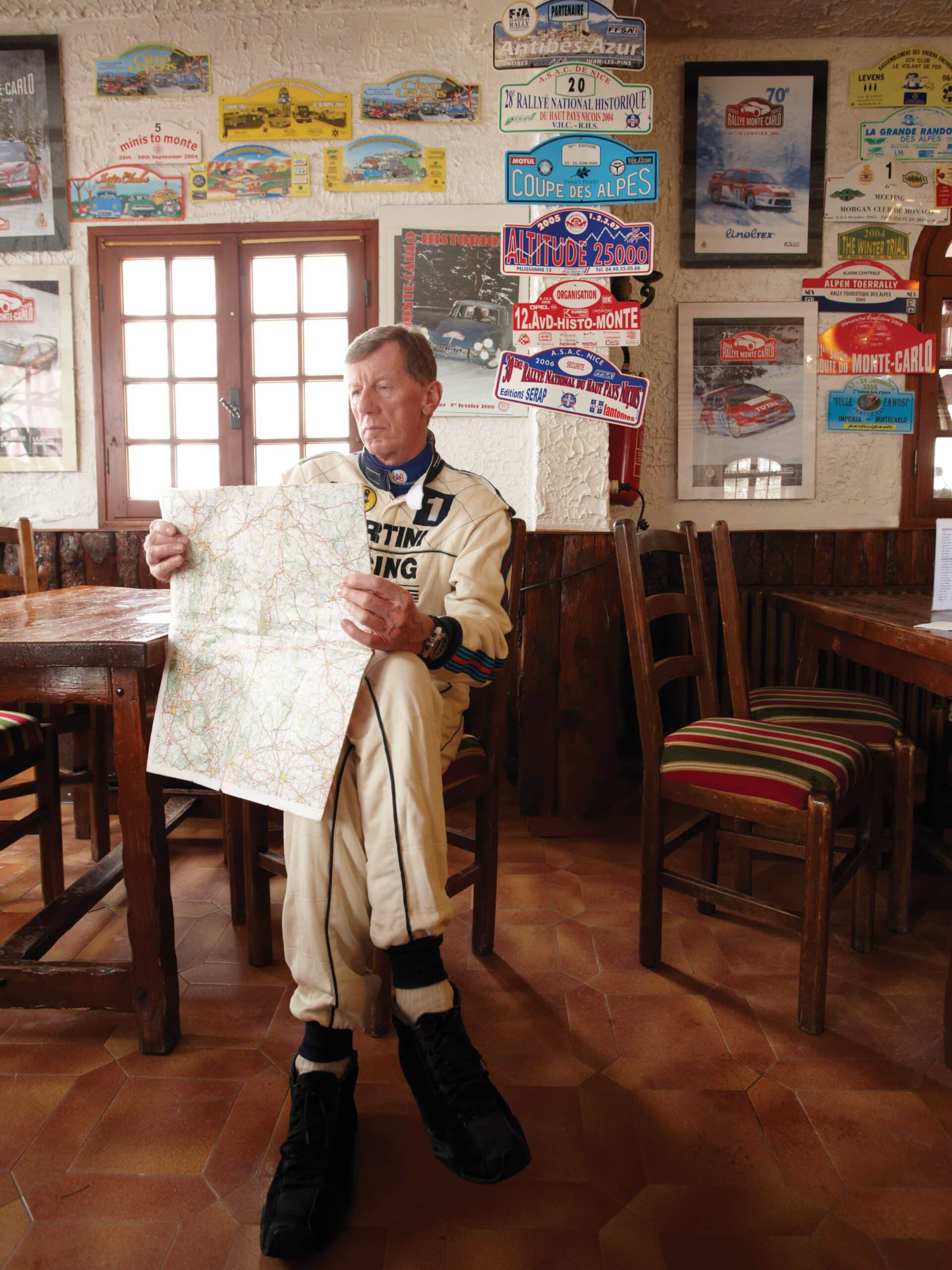 Walter Röhrl sitting and reading map