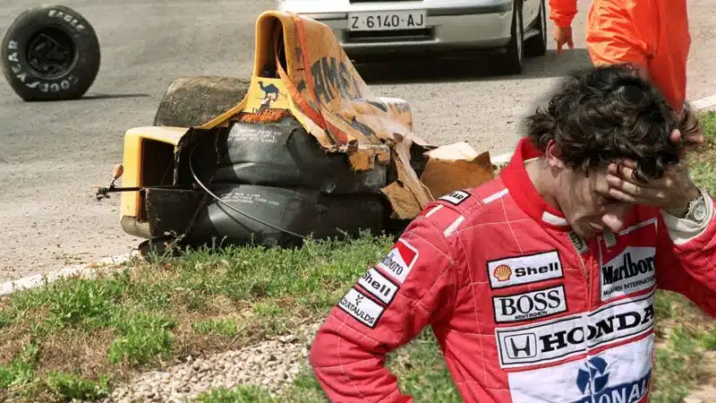 Ayrton Senna holds hed in his hands on image of destroyed Lotus of Martin Donnelly