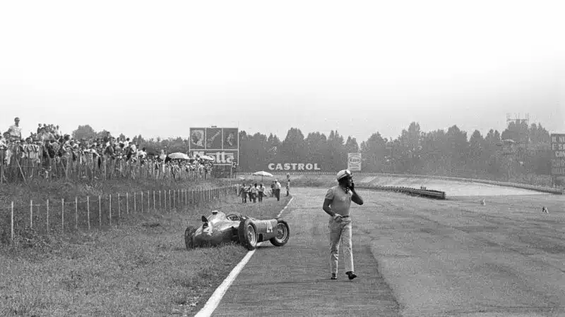 Eugenio Castellotti trudges from his Ferrari