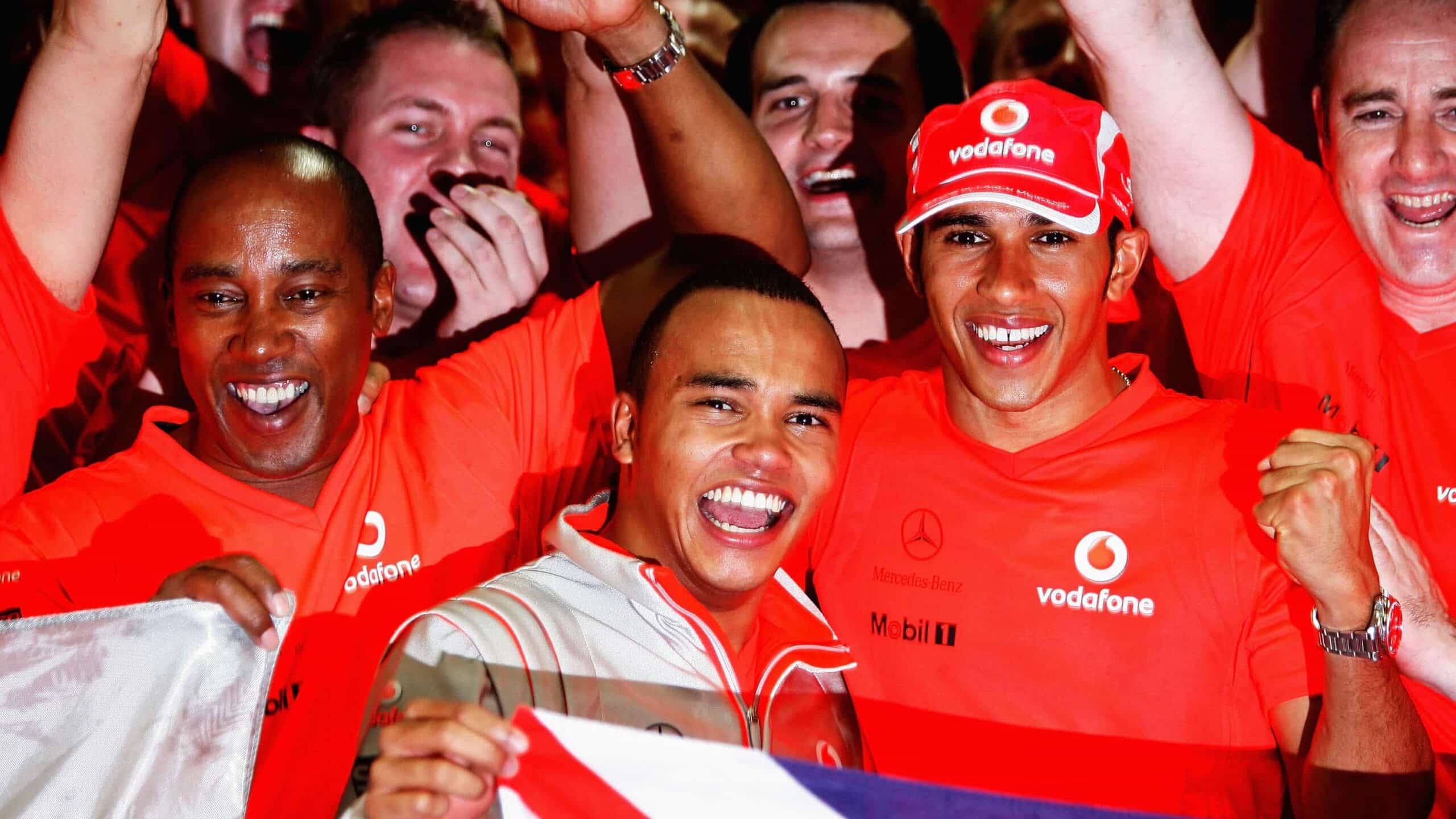 Lewis Hamilton celebrates with brother and father