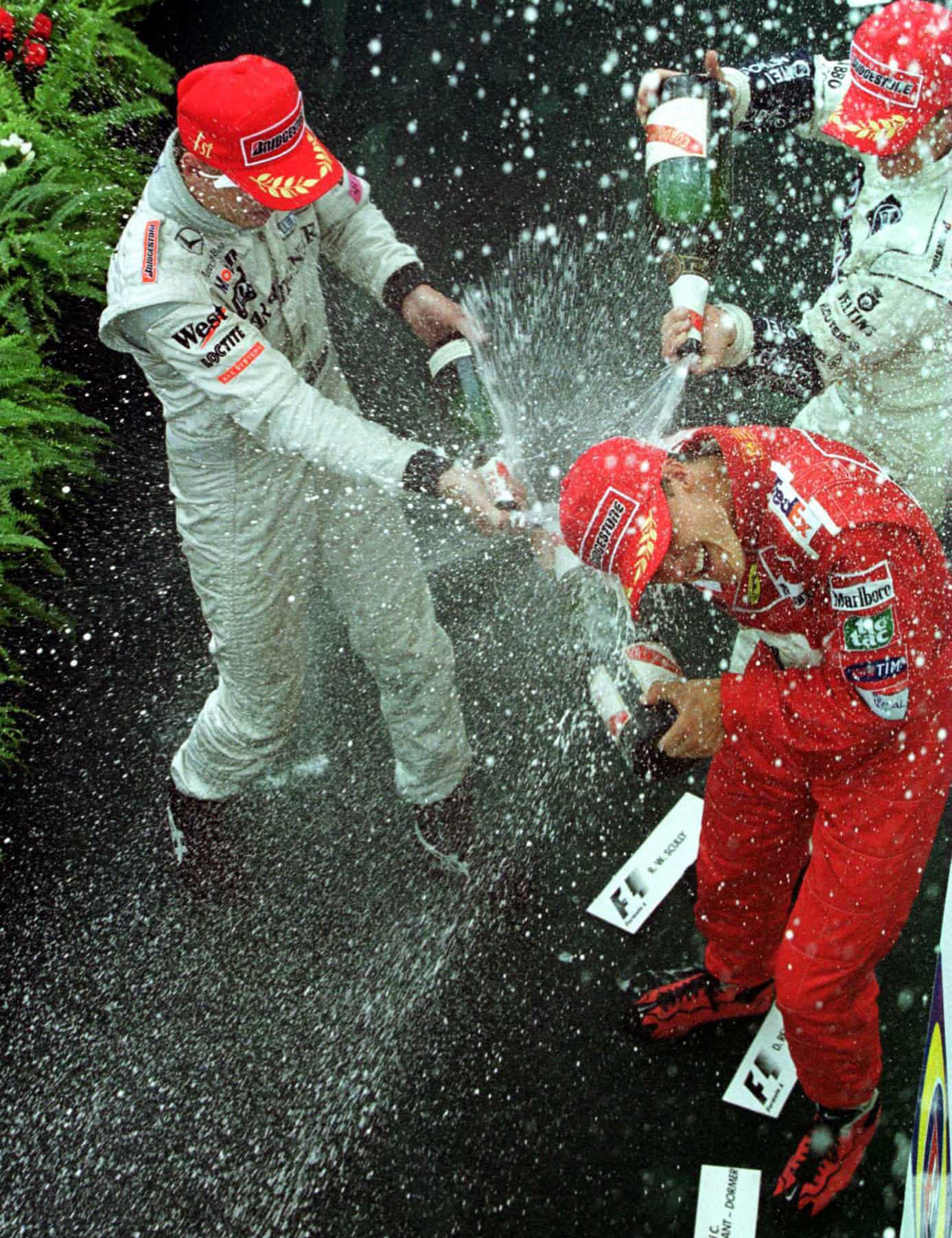 Mika Hakkine sprays Michael Schumacher