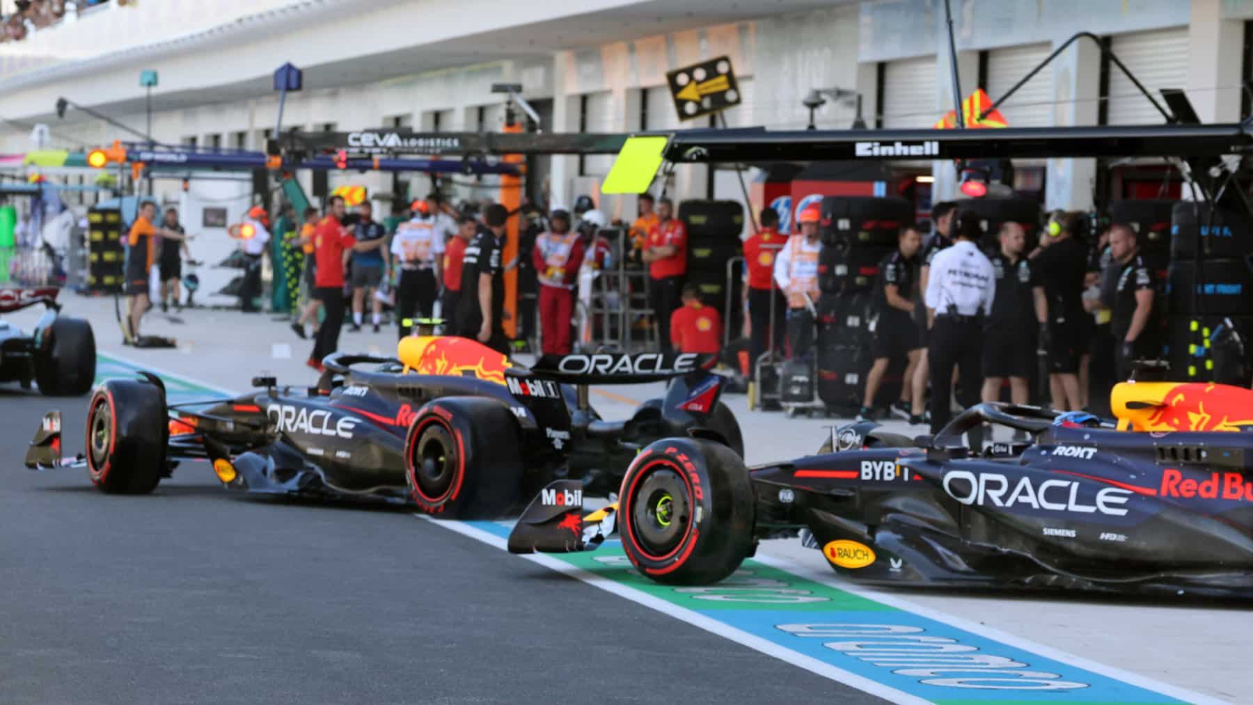 Sergio Perez and Max Verstappen (both Red Bull-Honda) leaves the pits during qualifying for the 2024 Miami Grand Prix