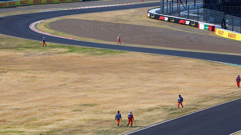 Marshals look for debris during practice for the Japanese GP