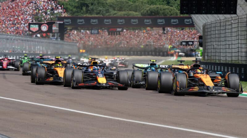 Max Verstappen (Red Bull-Honda) and Oscar Piastri (McLaren-Mercedes) lead the field at the start of the 2025 Emilia Romagna Grand Prix