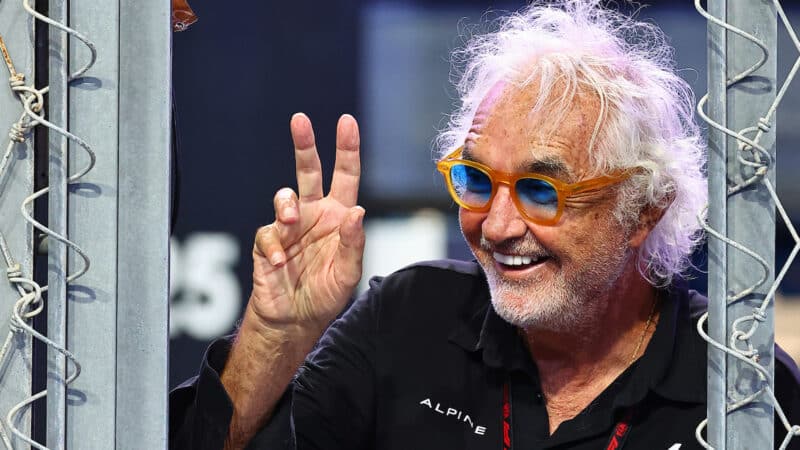 Flavio Briatore makes v victory sign from Alpine F1 pitwall