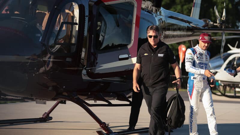Kyle Larson walks away from helicopter with Jeff Gordon