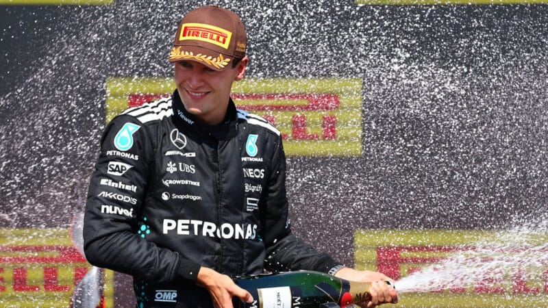 George Russell (Mercedes) sprays the champagne on the podium after the 2025 Canadian Grand Prix