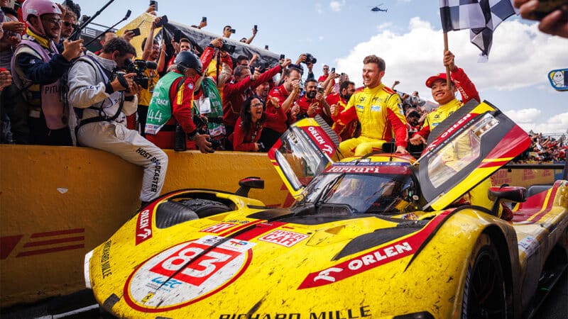 Phil Hanson and Yifei Ye sit on 2025 Le MAns 24 Hour winning Ferrari 499P Hypercar as Robert Kubica drives into the pitlane