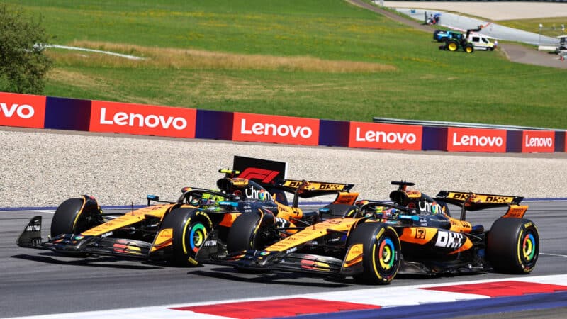 McLaren-Mercedes drivers Lando Norris and Oscar Piastri lead the field on the first lap after the start of the 2025 Austrian Grand Prix