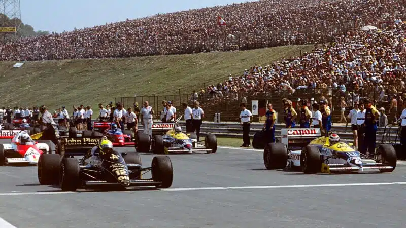 Ayrton Senna alongside Nelson Piquet on the front row of the grid at the start of the 1986 Hungarian Grand Prix