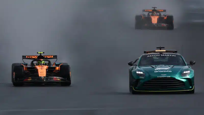 The safety car leads Lando Norris and Oscar Piastri at the Belgian GP