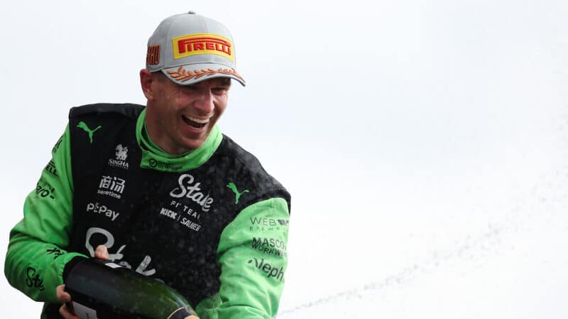 Nico Hulkenberg sprays champagne on the podium at the 2025 F1 British Grand Prix