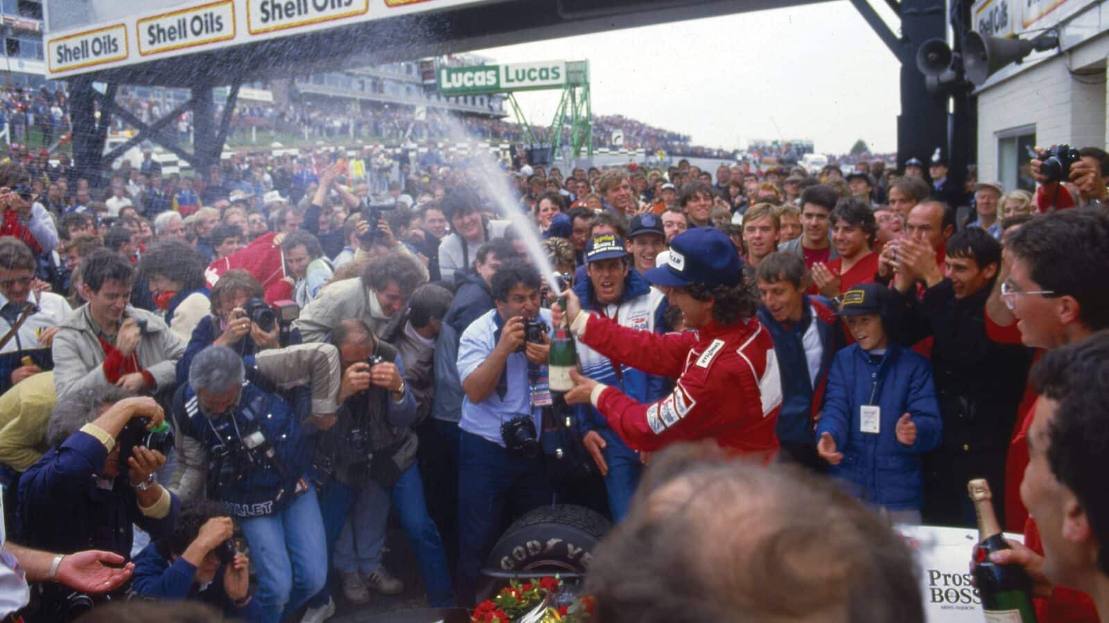 Alain Prost sprays the crowd
