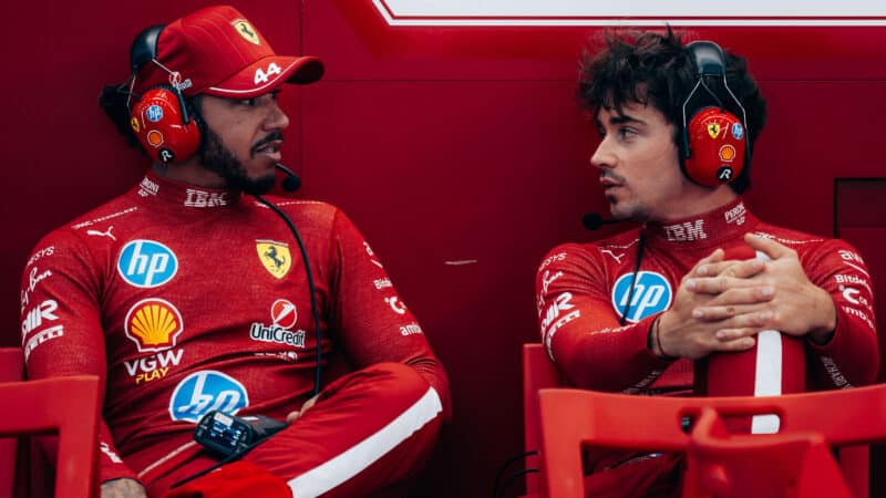 Lewis Hamilton and Charles Leclerc in Ferrari F1 pit garage