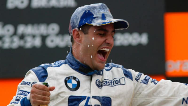 Williams-BMW driver Juan Pablo Montoya on the podium after winning the 2004 Brazilian Grand Prix
