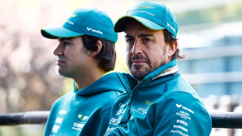 Fernando Alonso sits next to Aston MArtin F1 team mate Lance Stroll