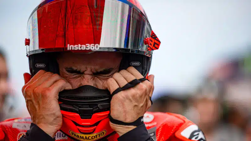 Marc Marquez squeezes his eyes closed as he puts on his helmet ahead of Misano MotoGP race in 2025