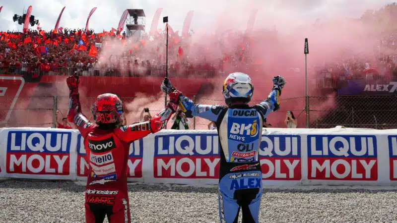 Marquez brothers greet cheering MotoGP fans in grandstands as they set off red smoke flares