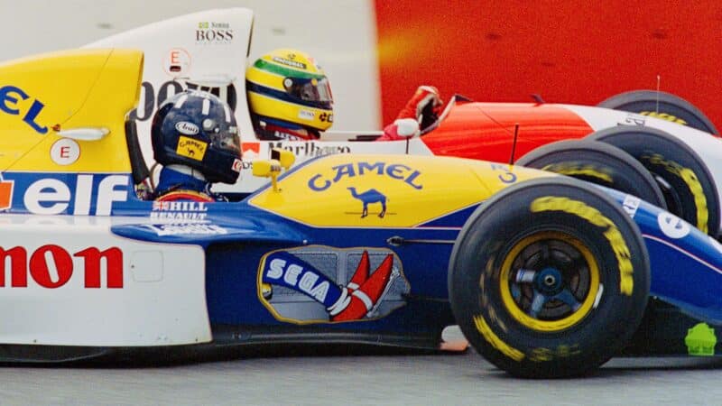 Williams F1 car of Damon Hill alongside McLaren on Ayrton Senna in 1993 Brazilian Grand Prix