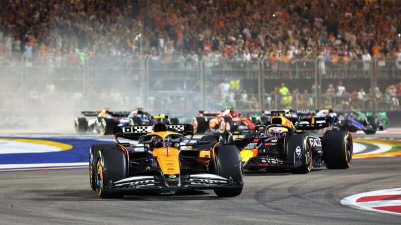 Lando Norris (McLaren-Mercedes) leads the field into the first corner after the start of the 2024 Singapore Grand Prix
