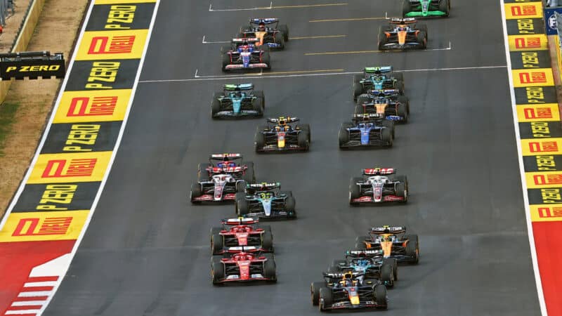 Max Verstappen (Red Bull-Honda) leads the field into the first corner after the start of the sprint race at the 2024 United States Grand Prix