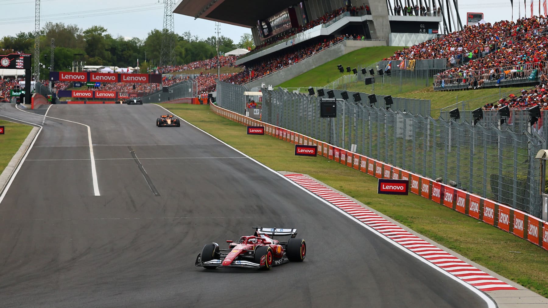 Charles Leclerc (Ferrari) leads Oscar Piastri (Ferrari) and the rest of the field during the 2025 Hungarian Grand Prix