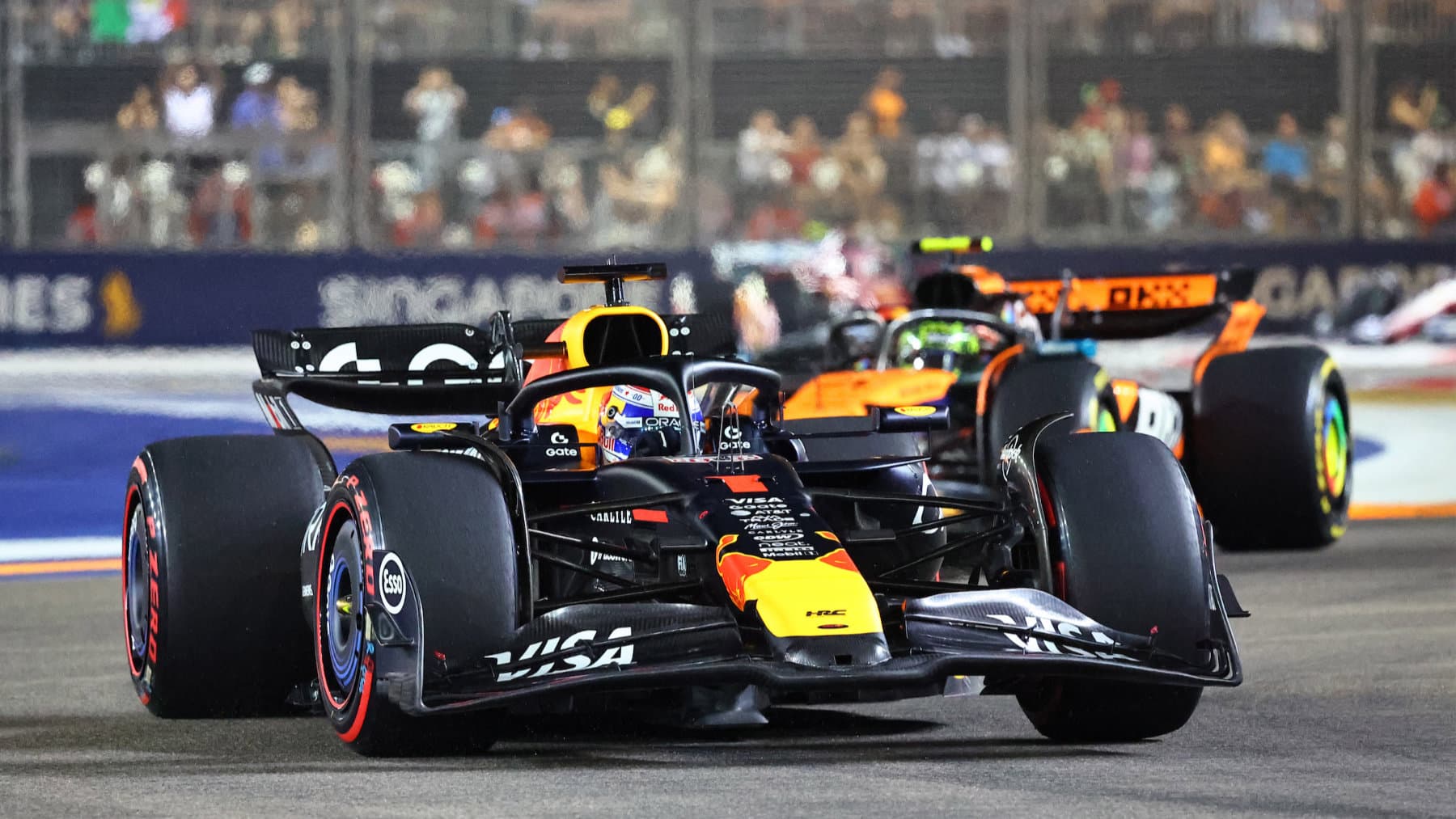 Max Verstappen (Red Bull-Honda) leads Lando Norris (McLaren-Mercedes) during the 2025 Singapore Grand Prix