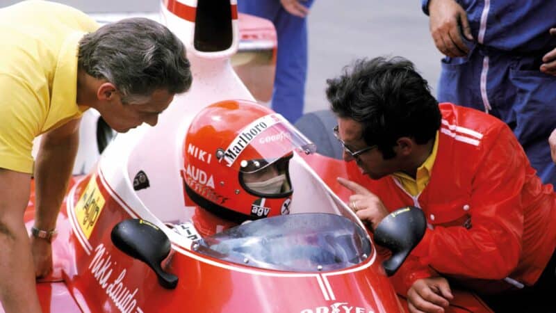 Forghieri leans in to offer Lauda some advice at Silverstone in 1975.