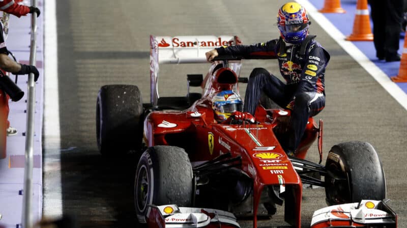 Marina Bay Circuit, Singapore. Sunday 22nd September 2013. Mark Webber, Red Bull Racing, gets a lift back with Fernando Alonso, Ferrari