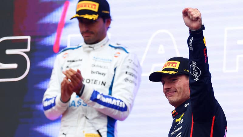Max Verstappen raises arm on Baku podium at the 2025 Azerbaijan Grand Prix