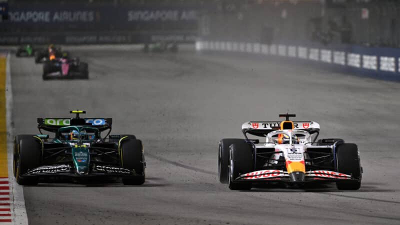 Fernando Alonso and Isack Hadjar battle during the Singapore Grand Prix