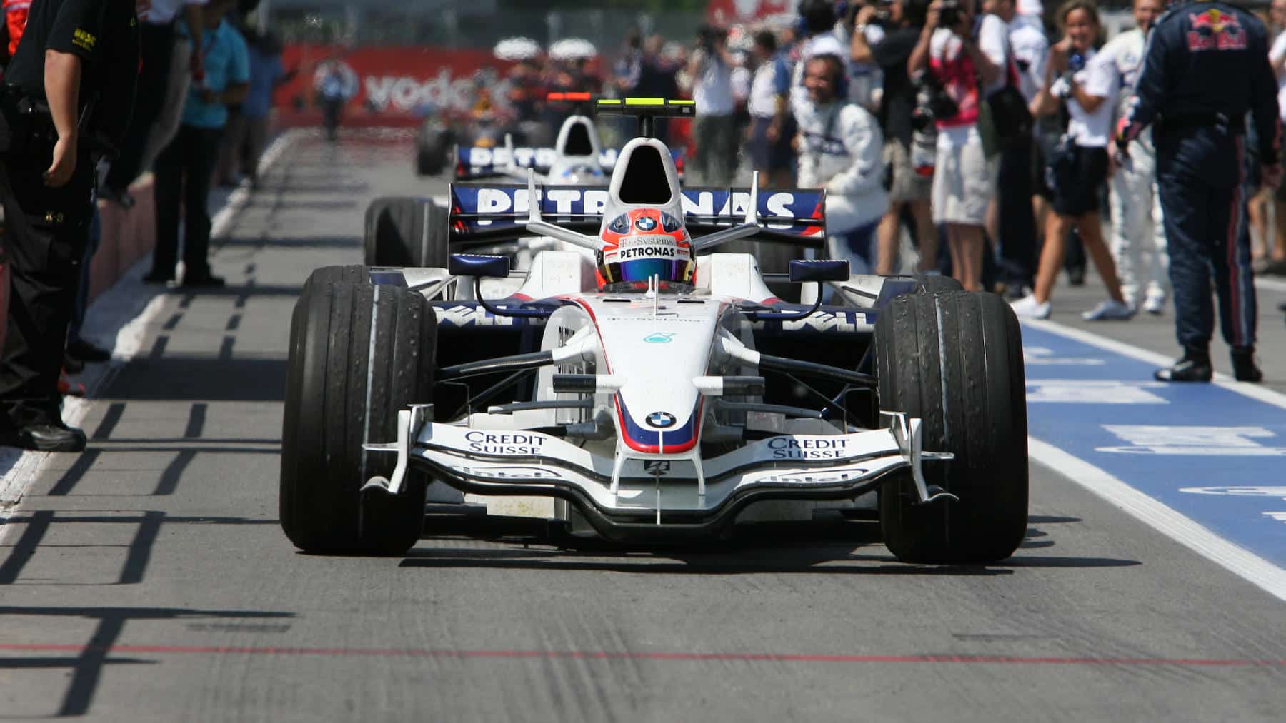 Robert Kubica and Nick Heidfeld (both BMW) return to the pits after the 2008 Canadian Grand Prix