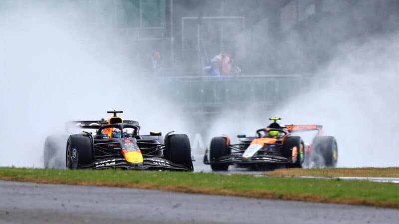 Max Verstappen (Red Bull-Honda) leads Lando Norris (McLaren-Mercedes) during the wet 2025 British Grand Prix