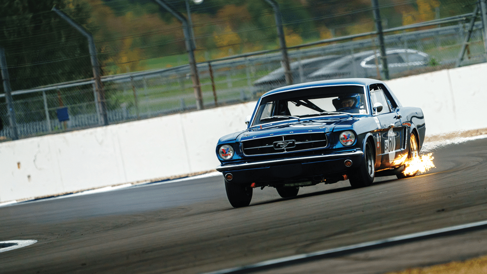 Mustang of Andrew Haddon and Andy Wolfe spits flame at Motor Racing Legends’ season finale at Silverstone