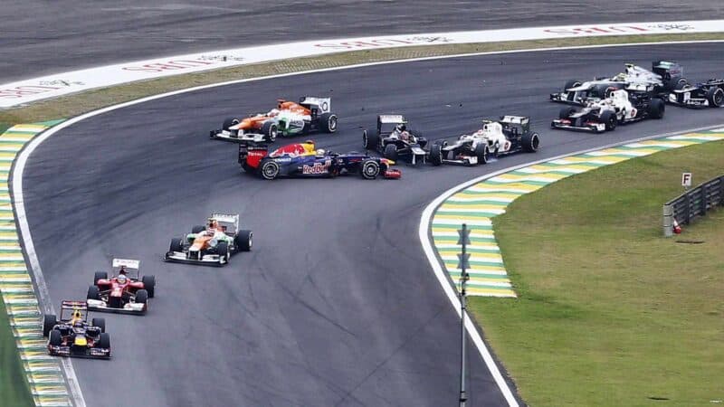 Sebastian Vettel of Germany and Red Bull Racing spins after being involved in an incident with Bruno Senna of Brazil and Williams during the Brazilian Formula One Grand Prix at the Autodromo Jose Carlos Pace on November 25, 2012