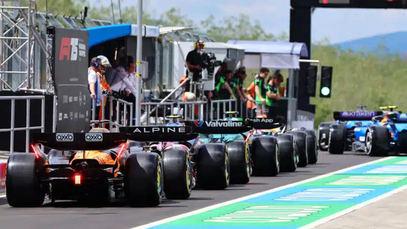 Cars in the pits waiting for practice before the 2025 Hungarian Grand Prix at the Hungaroring